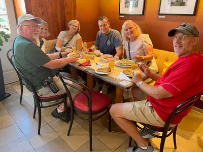Butch and his group enjoying "Zwiebelkuchen" and "Neuer Wein" at a family-owned restaurant.