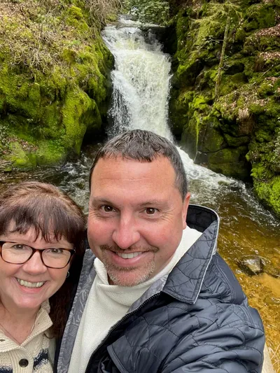 Manfred's guests Theresa and Craig in front of a Black Forest waterfall.